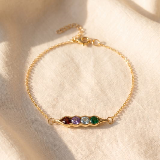 The pea pod bracelet in gold, with four birthstones