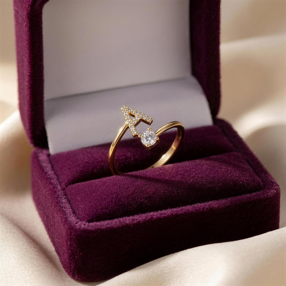 Gold initial ring with letter A in a plum velvet gift box