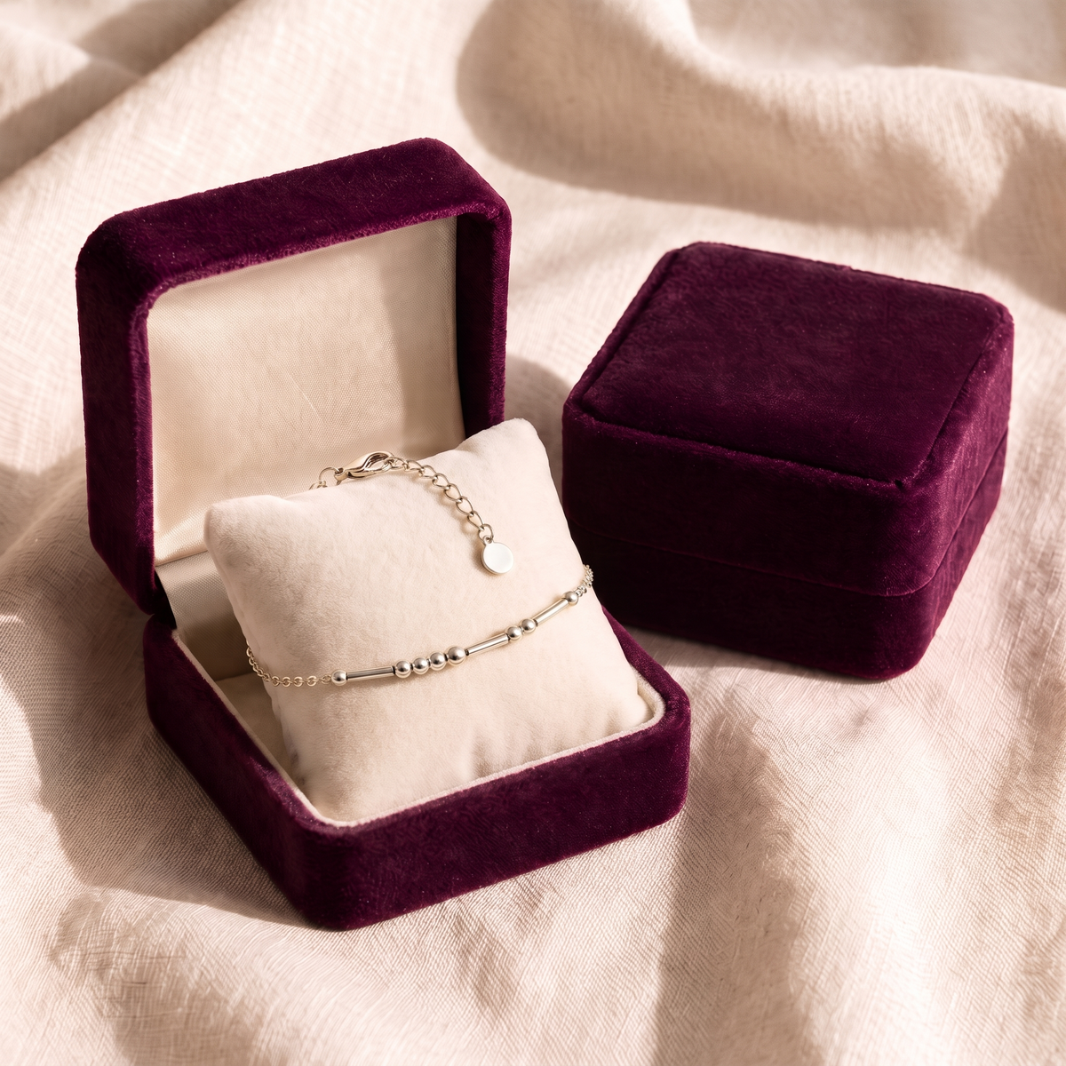 The silver Morse code bracelet in a plum velvet gift box