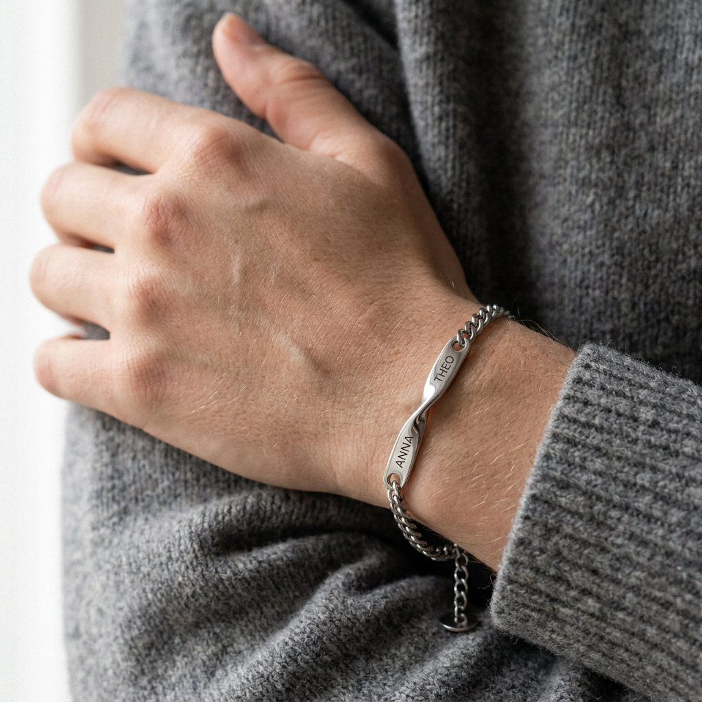 Close-up of a wrist wearing the bracelet, ANNA and THEO engraved on each side of the twist