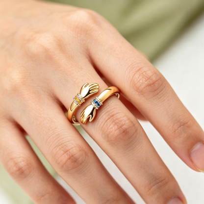 The gold hug ring worn on a finger