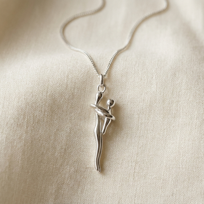 All silver hug necklace on ivory linen