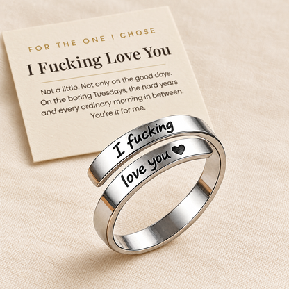 The silver engraved ring beside its printed card