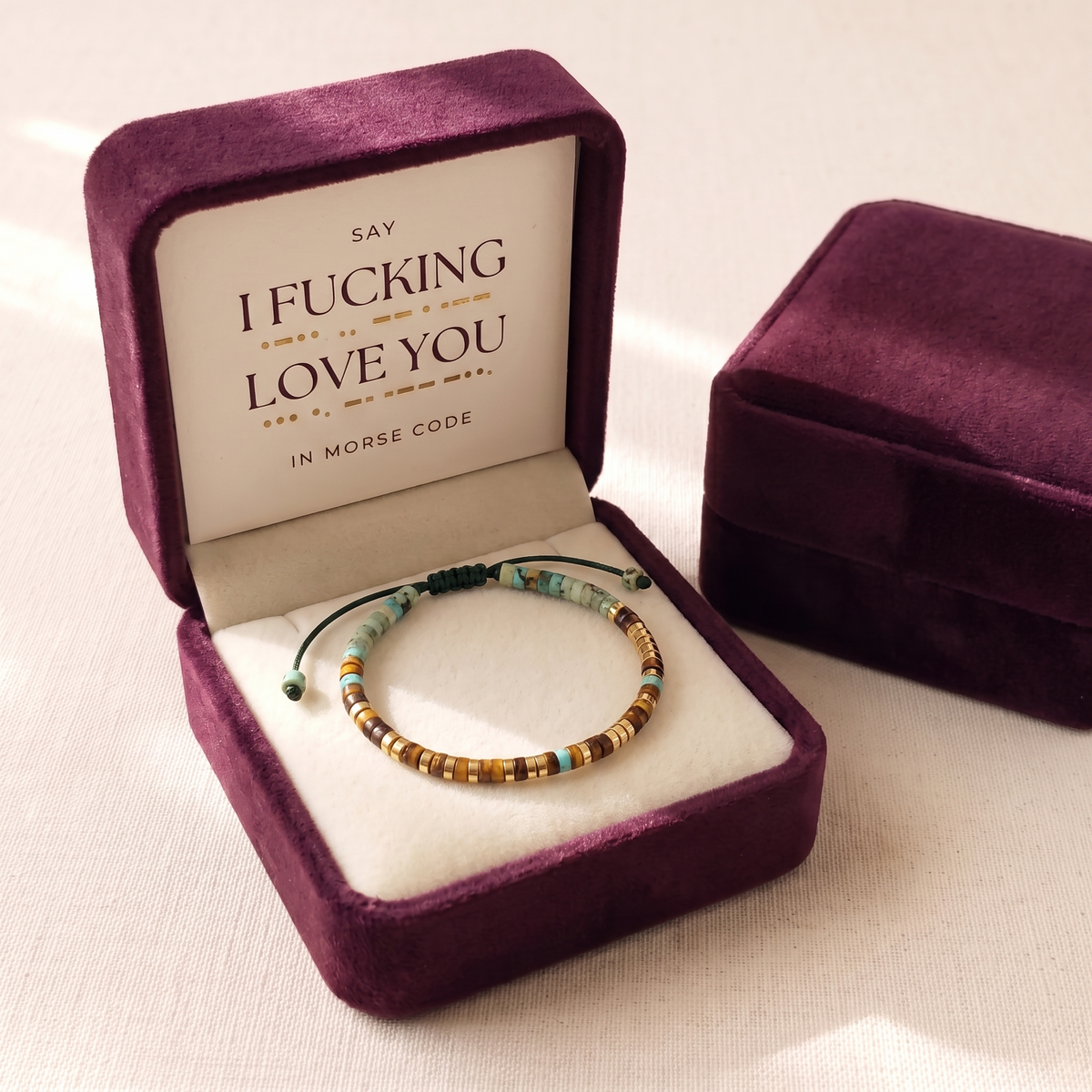 The bracelet in its plum velvet gift box with the card