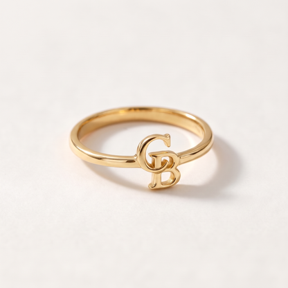 Gold ring with two interlocking serif initials