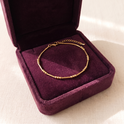 The gold bracelet in its plum velvet gift box