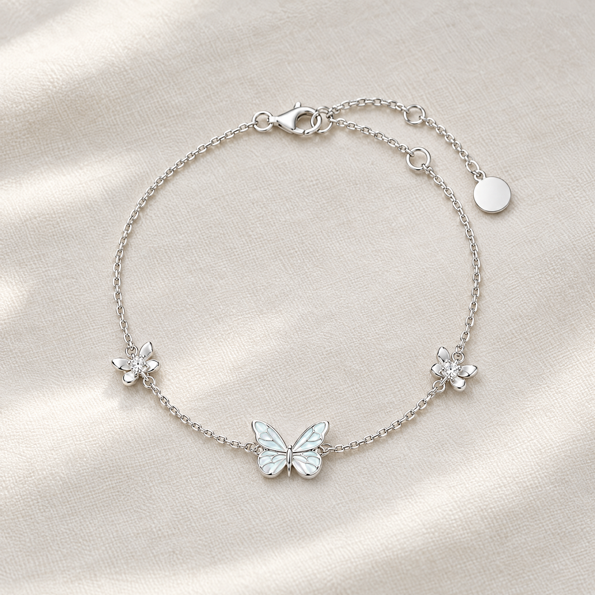 Silver butterfly bracelet with two crystal flowers on ivory linen