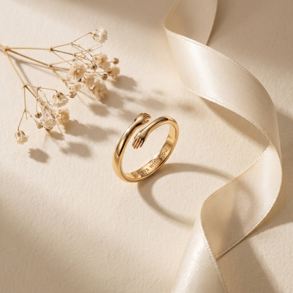 Gold hug ring flat lay with dried flowers and silk ribbon