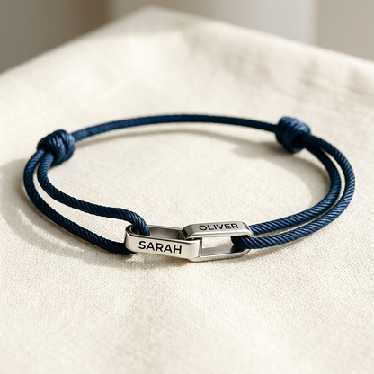 Silver links on navy cord, engraved SARAH and OLIVER
