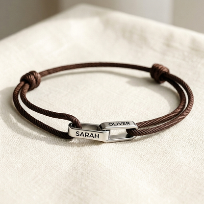 Silver links on brown cord