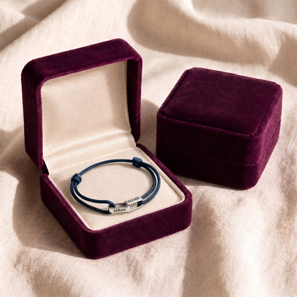The bracelet laid flat in its plum velvet gift box