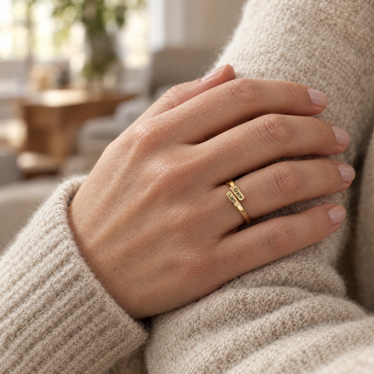 The gold ring worn on a woman's ring finger, the two engraved names on top