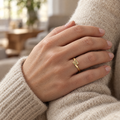 The gold ring worn on a woman's ring finger, the two engraved names on top