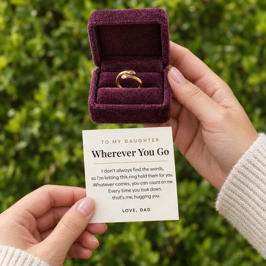 Hands holding the plum gift box with the gold hug ring and the small To My Daughter card from Dad