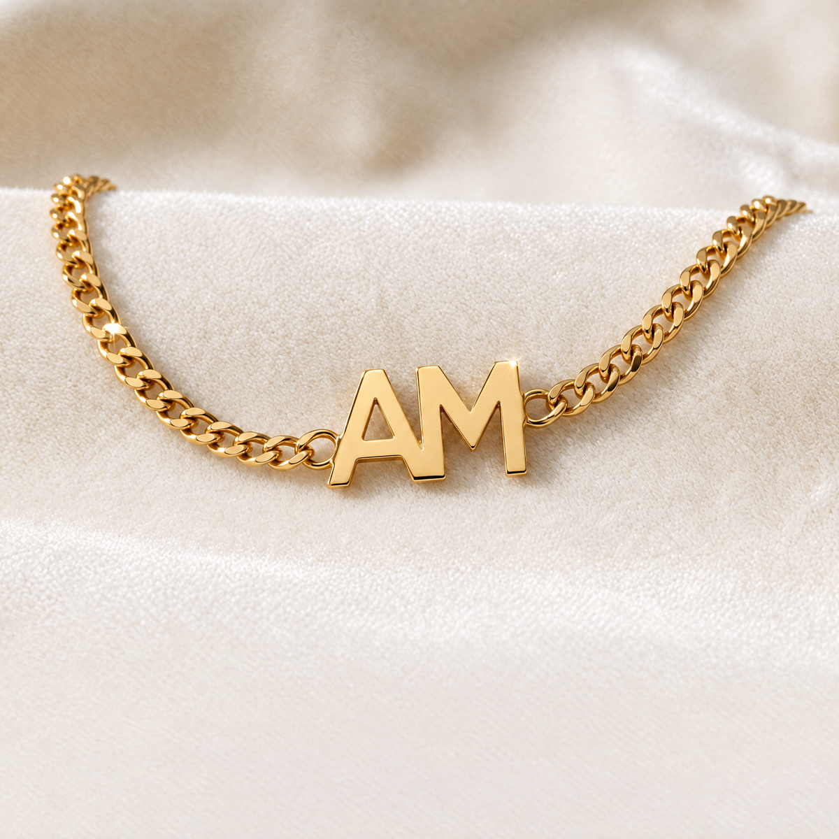 Gold curb chain bracelet with the initials A and M side by side