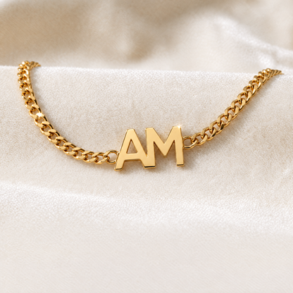 Gold curb chain bracelet with the initials A and M side by side