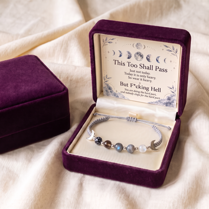 Silver cord bracelet in an open plum gift box with the keepsake card