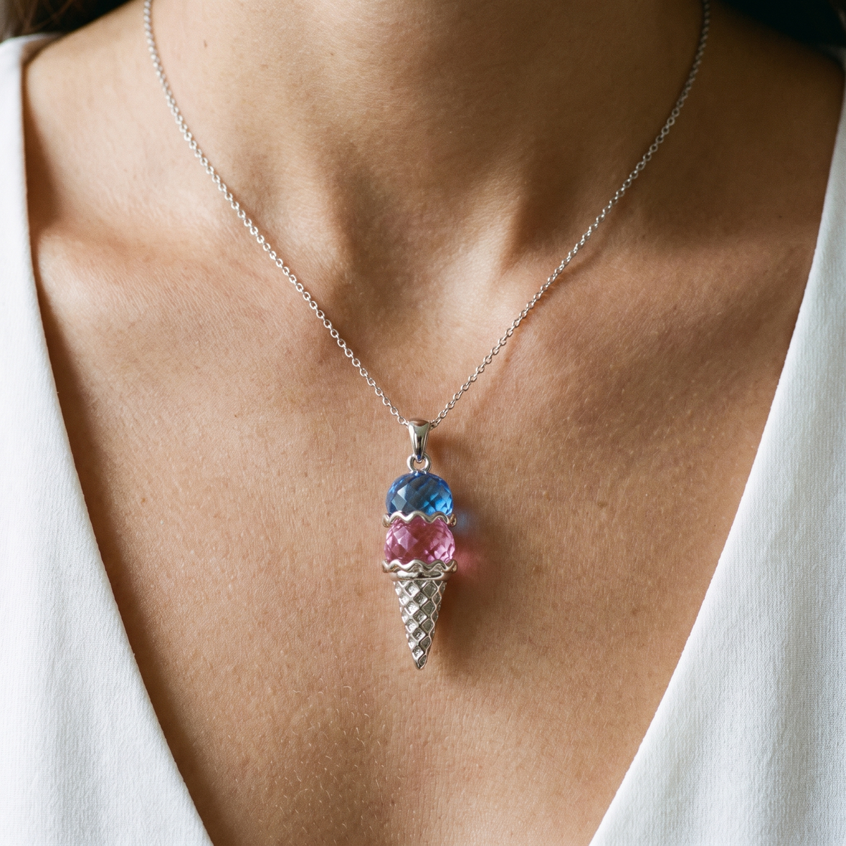 The pendant worn against a white top