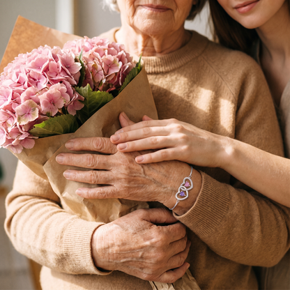 A mother holding flowers, her daughter's hands over hers