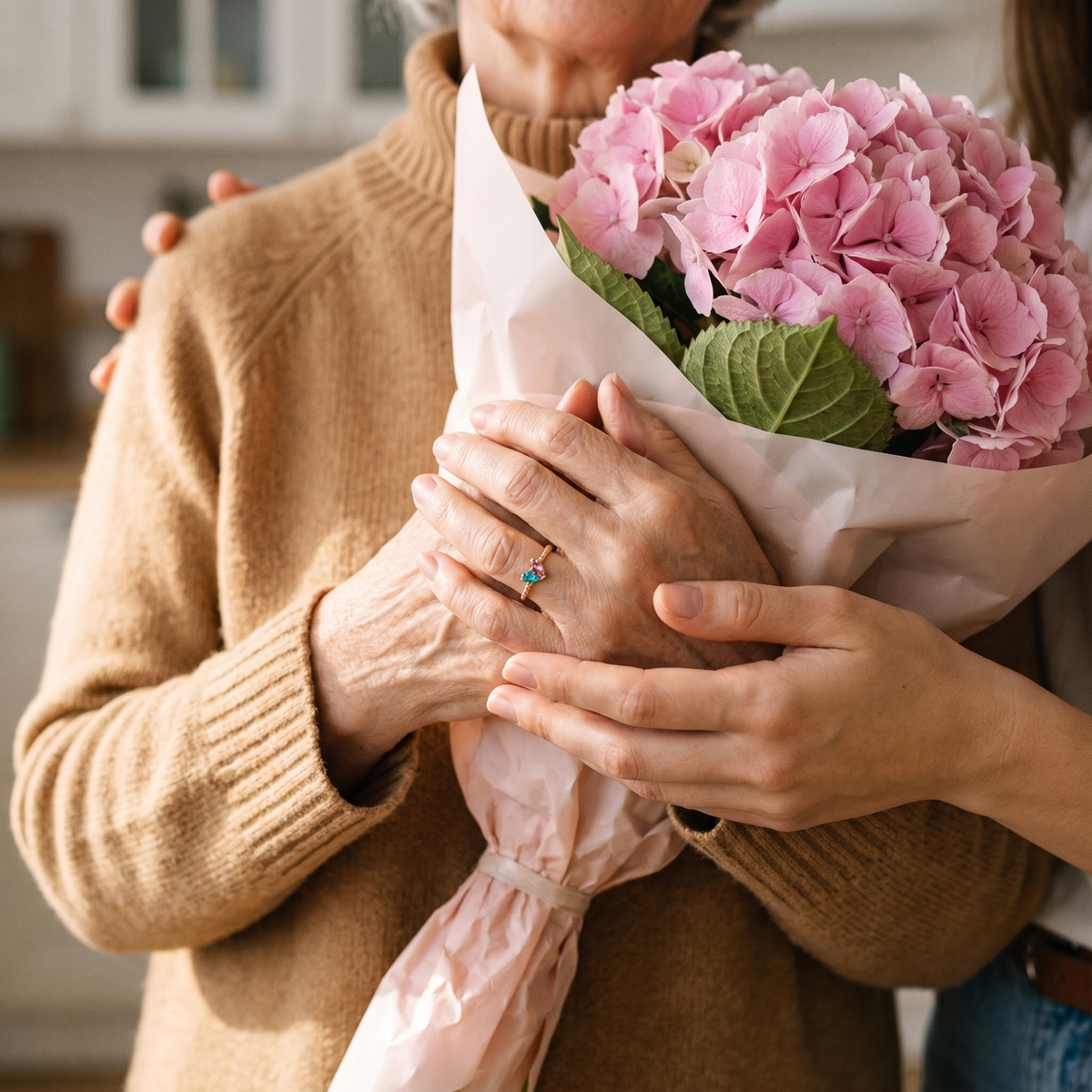 A mother holding flowers, wearing the ring, her daughter's hands over hers