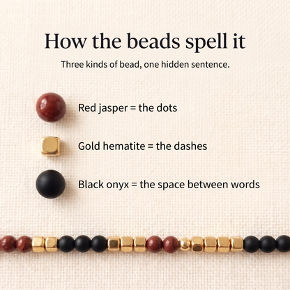 How the beads spell it: red jasper dots, gold hematite dashes, black onyx word breaks