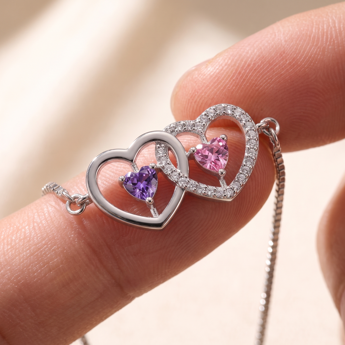 Macro of the two interlocking hearts and their birthstones