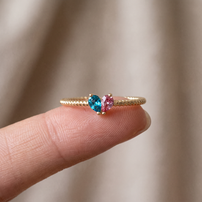 The ring balanced on a fingertip, to show how dainty it is