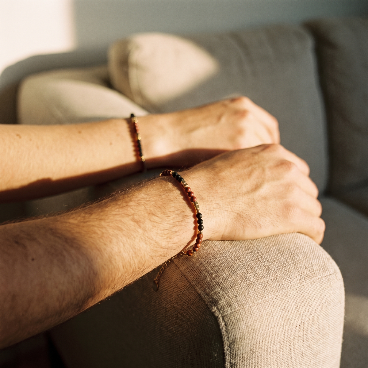 Two wrists side by side, both wearing the bracelet