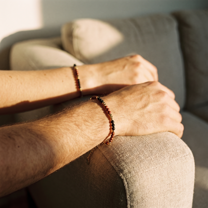 Two wrists side by side, both wearing the bracelet