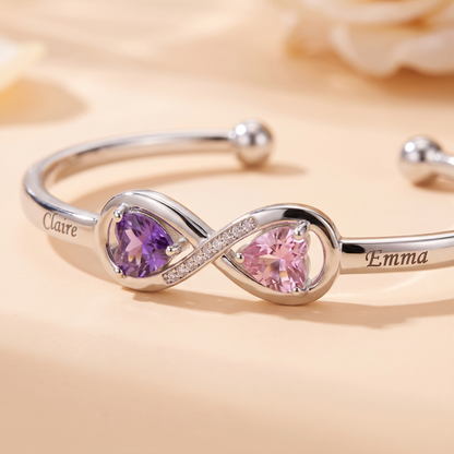 Macro of the infinity, the two birthstones and the engraved names