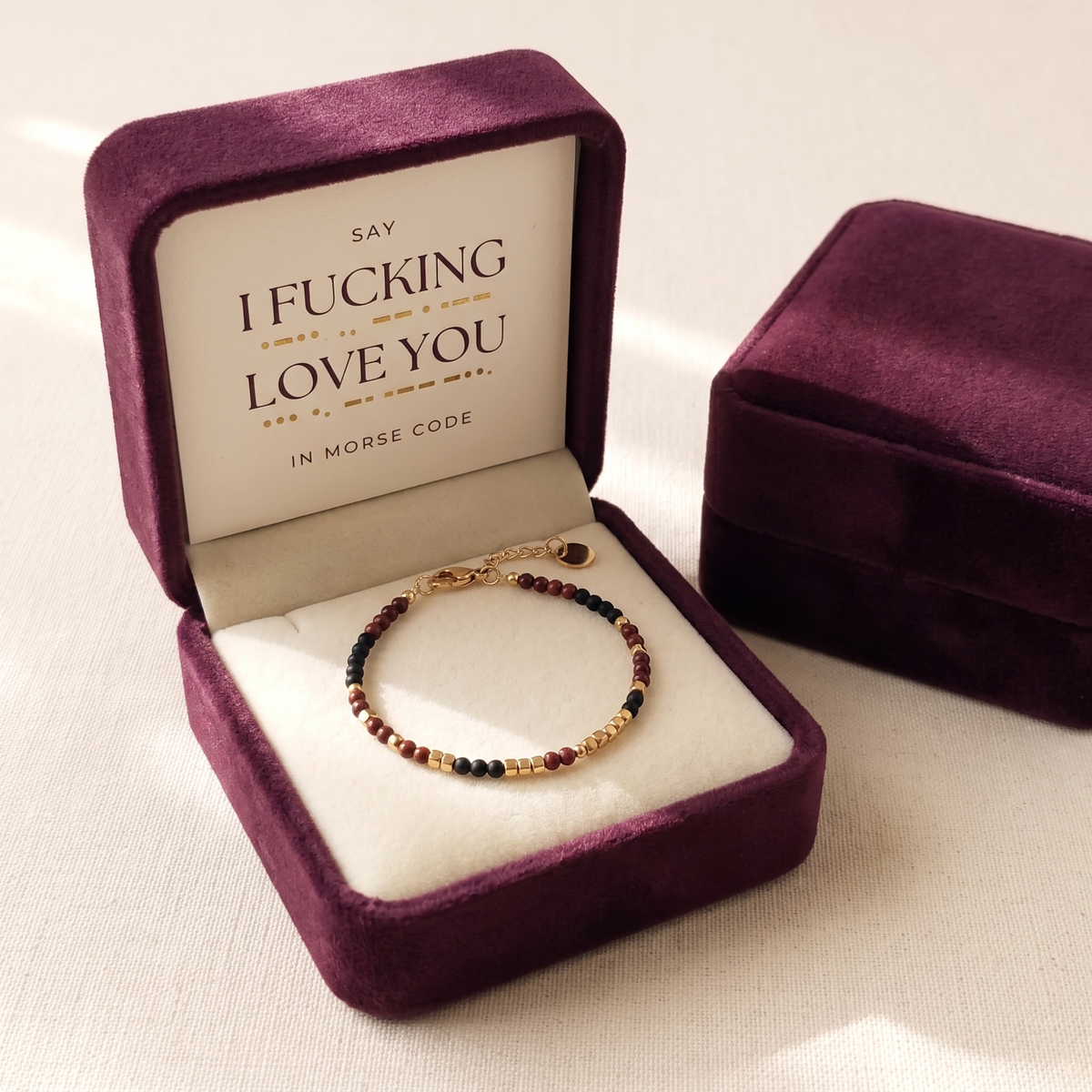 The gift box open with the card and the bracelet inside