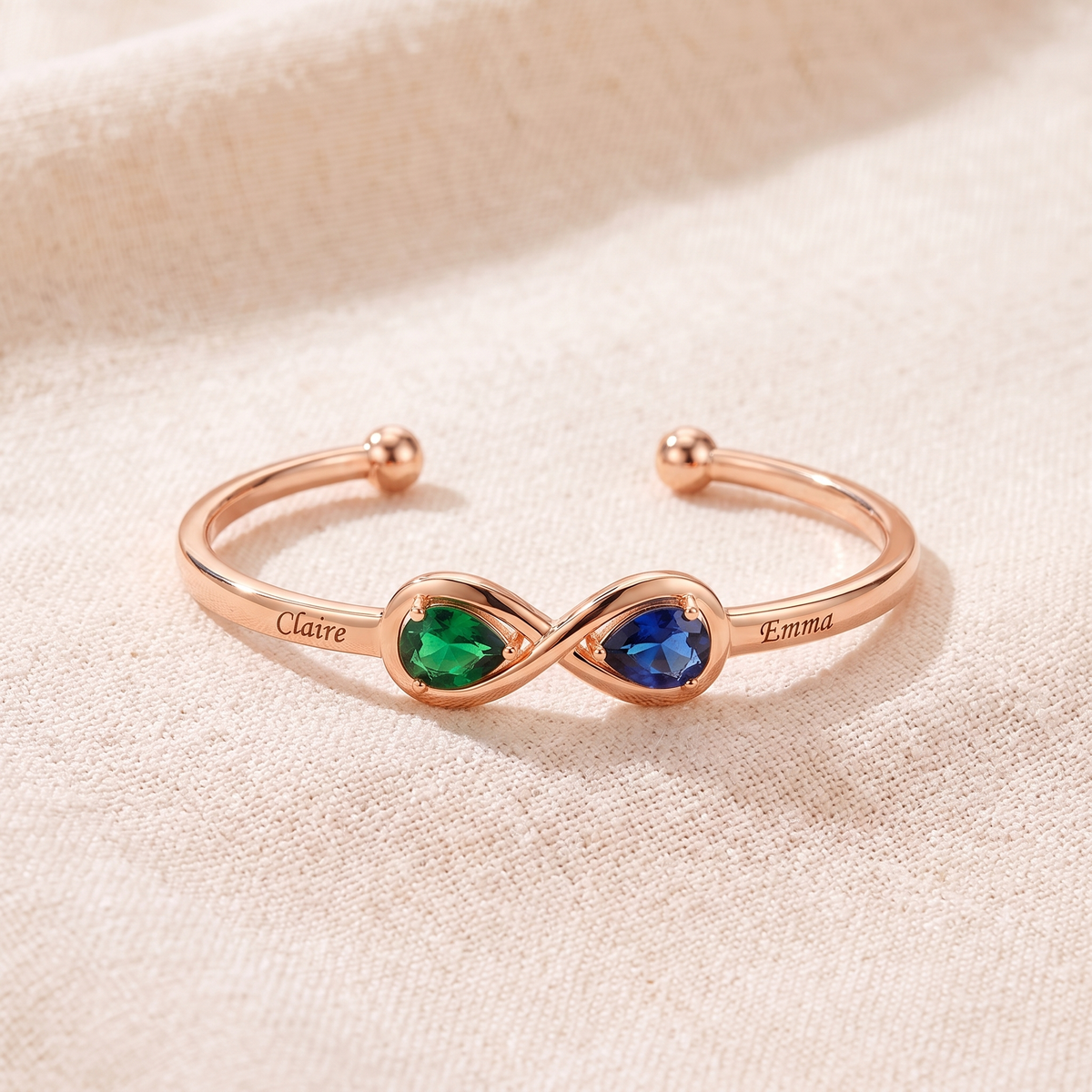 The engraved infinity cuff in rose gold with two heart birthstones